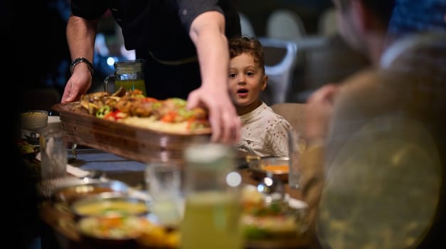 In a heartwarming scene, a professional chef serves an European Muslim family their iftar meal during the holy month of Ramadan, embodying cultural unity and culinary hospitality in a moment of shared celebration and gratitude.