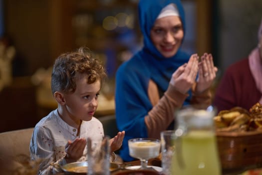 In a modern restaurant setting, a European Islamic family comes together for iftar during Ramadan, engaging in prayer before the meal, uniting tradition and contemporary practices in a celebration of faith and family.