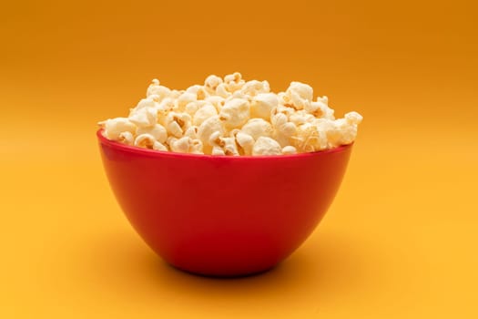 National Popcorn Lover's Day. Popcorn in Red Bowl on Yellow Background. Movie, Cinema. Greeting Card. Tasty salted Snack Flat Lay, Horizontal Plane