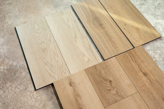Top View Luxury Vinyl Wood Samples Lying On Concrete Floor In House. Choosing, Selecting Waterproof Flooring. Home Reconstruction. Vinyl Tiles Collection, Patterns. Interior Design Idea. Horizontal