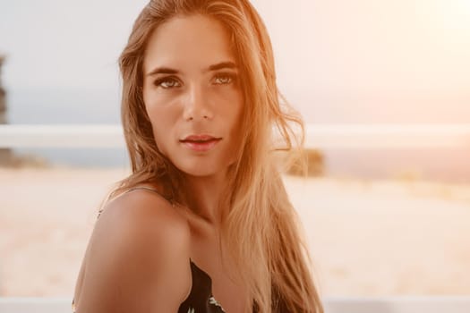 Happy woman portrait in cafe. Boho chic fashion style. Outdoor photo of young happy woman with long hair, sunny weather outdoors sitting in modern cafe