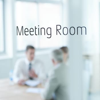 Business people, glass and meeting room sign for boardroom planning, collaboration or teamwork. Group, blurry or employees with strategy for discussion, conversation or brainstorming at workplace.