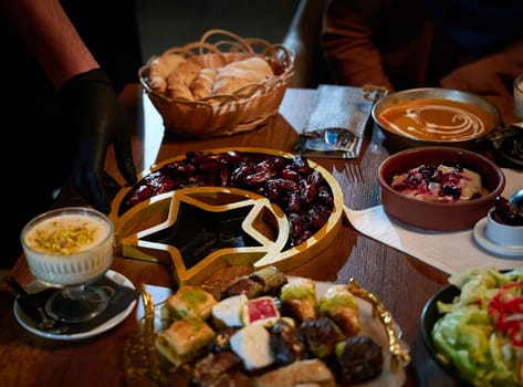 In this captivating aerial view, delicious food adorned with Ramadan decorations, including dates and meat, awaits the arrival of an European Islamic family, promising a festive and flavorful iftar celebration.