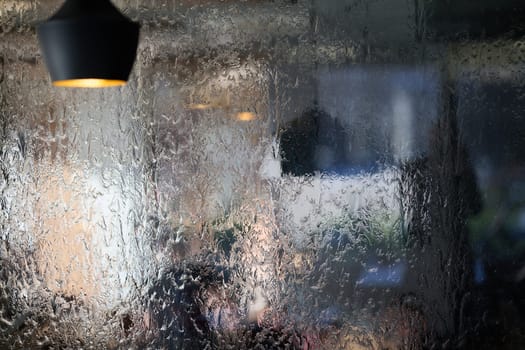 In a close-up capture, the texture of glass through which water flows is beautifully depicted, showcasing intricate patterns and the fluidity of movement in a mesmerizing display.