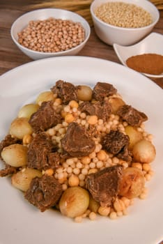 Moughrabieh is a popular dish in the Lebanese cuisine, LEBANESE RECIPE FOR MOUGHRABIEH WITH BEEF AND SMALL ONIONS, SEMOLINA PEARLS AND CHICKPEAS. High quality photo