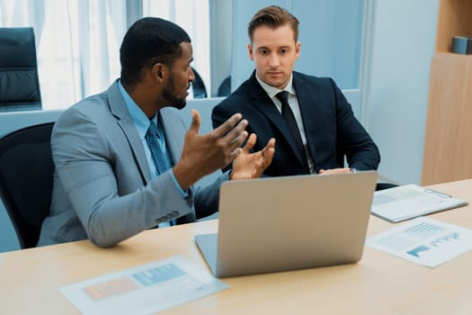 Cooperative handsome african businessman present start up project while manager listen and decide to invest. Two businesspeople making agreement, reporting data. Multicultural business. Ornamented.