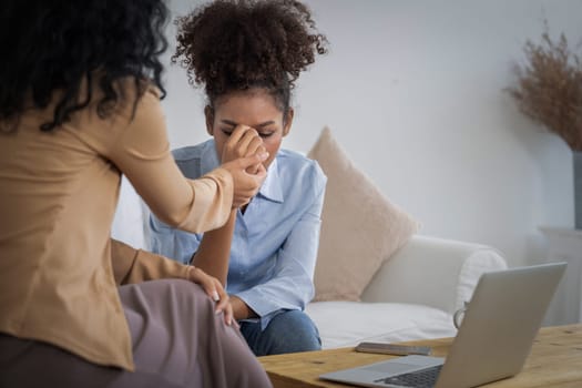 Sad PTSD woman patient in crucial therapy for mental health with psychologist, depression or grief after life failure. Frustrated trauma young woman talking to a psychologist about emotion in clinic