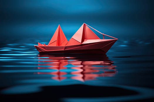 Red paper boat on calm blue water.