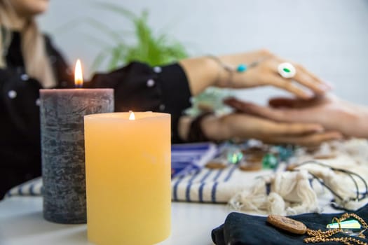 A fortune teller reads with tarot cards. Selective focus. Woman.