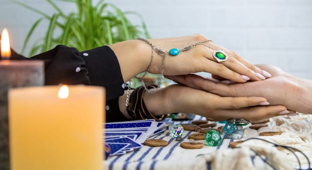 A fortune teller reads with tarot cards. Selective focus. Woman.