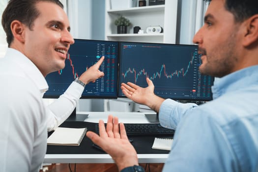 Successful stock exchange traders focusing on high profit chart investment on dynamic database, analyzing on monitor. Concept of discussing financial technology growth at workplace. Sellable.