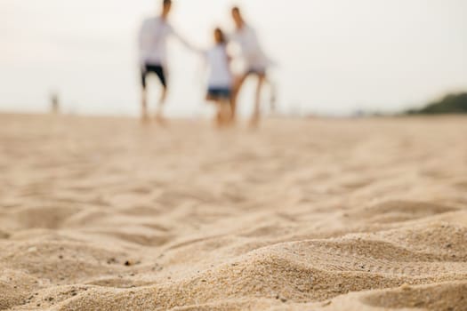 Cheerful beach moments with a happy family. Smiling father and mother son and daughter playing walking and laughing. Carefree joy family bonding and summer relaxation. Family on beach vacation