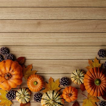 Top view Halloween decoration made from autumn leaves and pumpkin on wooden background. Flat lay, top view with copy space. 3d render..