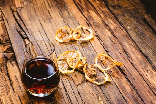 Close Up of a Glass of Sweet Madeira Fortified Wine on wooden table.