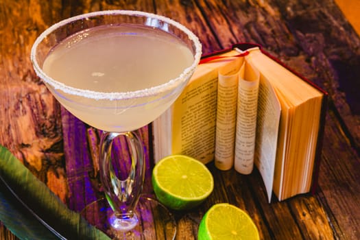 Margarita cocktail with lime in a glass on wooden table. Shallow dof.