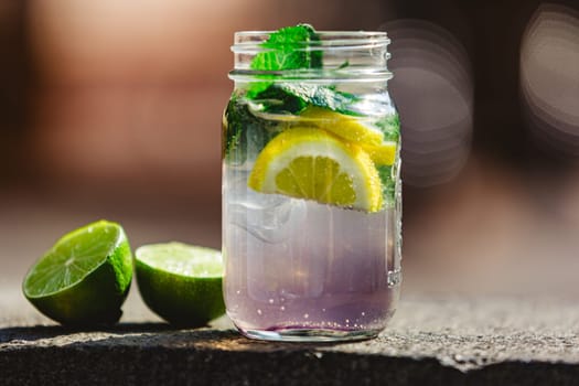 Glass of lime lemonade. Summer refreshing drinks. Homemade lemonade with lime and orange. Cold drinks