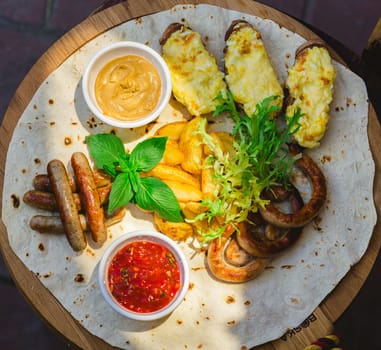 German style grilled sausages with potato wedges and bread with cheese and sauces close-up on a wooden tray on the table. Shallow dof