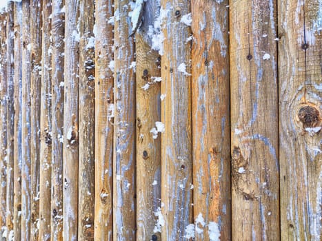 Wooden fence boards with snow as background, texture, pattern, place for text and copy space