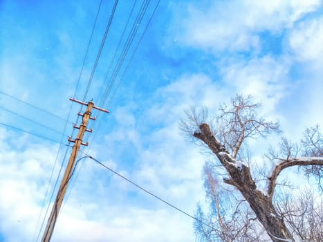 Old pole with wires against the sky. Electric transmission line, Eco-friendly energy