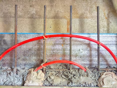 Installation of polypropylene pipes for underfloor heating systems, concrete floor filling