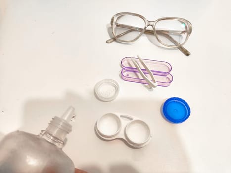 Set for contact lenses with a container, forceps, glasses. The concept of correcting myopia. Contact lens care, cleaning, health. Background, copy space