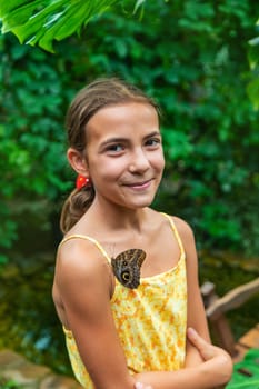 A child holds a beautiful butterfly. Selective focus. Nature.