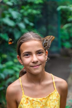 A child holds a beautiful butterfly. Selective focus. Nature.