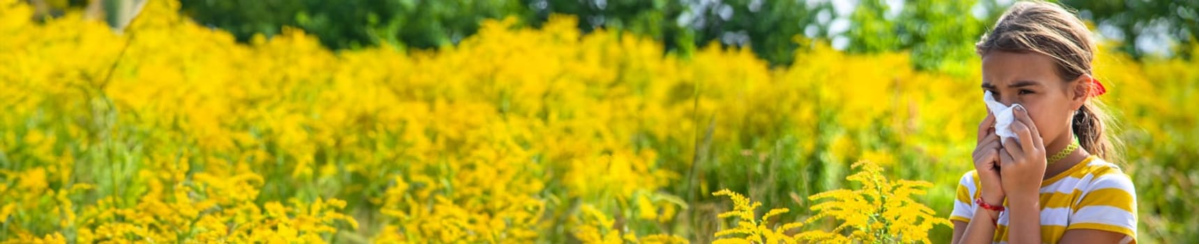 A child is allergic to ragweed blooming in the park. Selective focus. Nature.