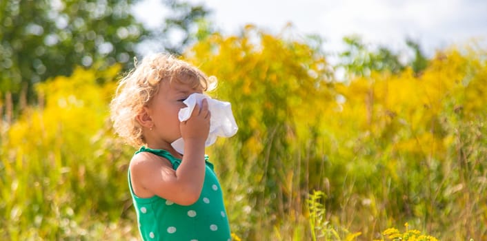 A child is allergic to ragweed blooming in the park. Selective focus. Nature.