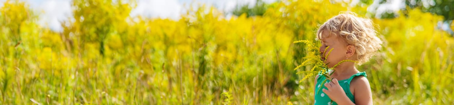 A child is allergic to ragweed blooming in the park. Selective focus. Nature.