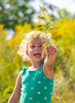 A child is allergic to ragweed blooming in the park. Selective focus. Nature.