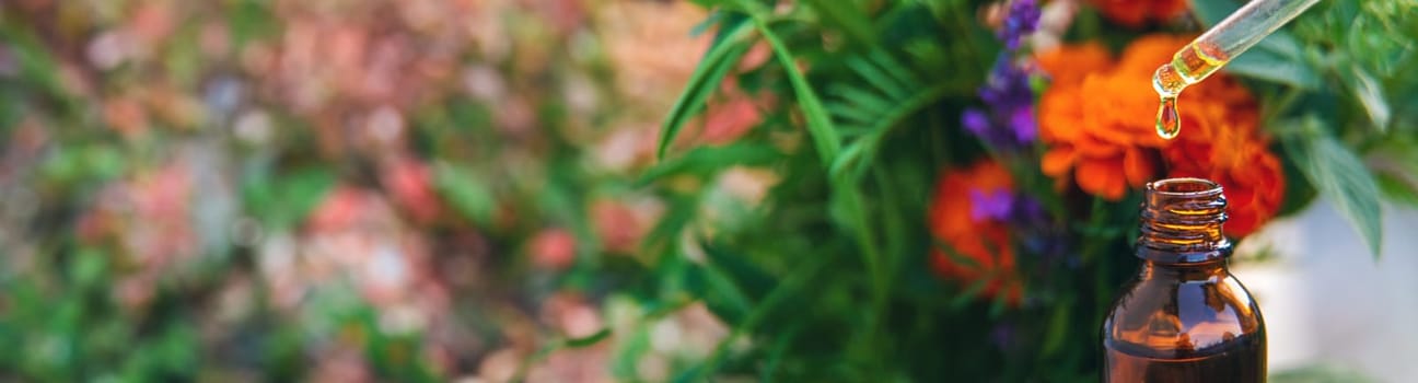 Essential oil of flowers and herbs drop. Selective focus. Nature.