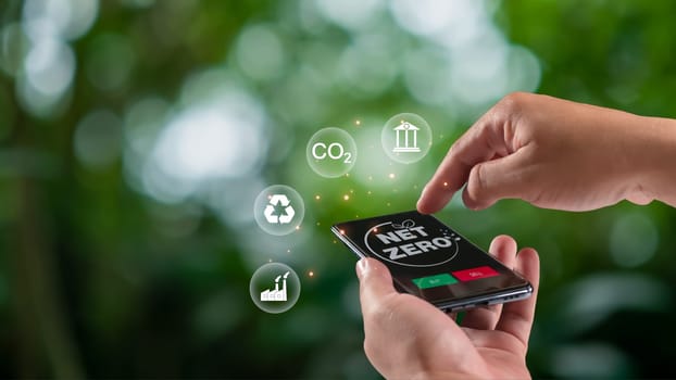 Human using a smartphone to trade carbon credit on application, carbon credit concept, carbon etf to invest in sustainable business, green climate funds investment, Net zero emission, Clean technology