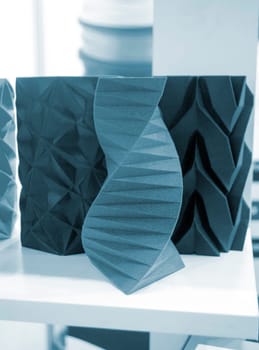 Art object vase printed on a 3D printer. Models created by a 3D printer from blue molten plastic. Concept 3d printing. Additive progressive technologies. New modern technology for creating objects