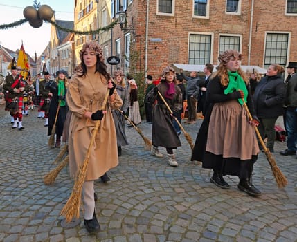 Deventer, Netherlands, December 16, 2023:Cleaners and a bagpipes orchestra in the streets of Deventer in victorian style cloting during the Dickens Festival