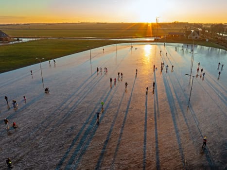 Aerial from ice skating at sunset on the ice rink in Koudum Friesland the Netherlands