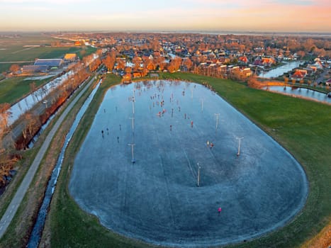 Aerial from ice skating at sunset on the ice rink in Koudum Friesland the Netherlands