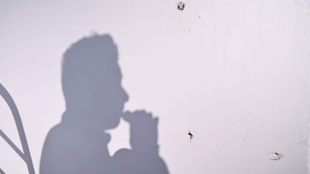 Young man using an e-cigarette on white background