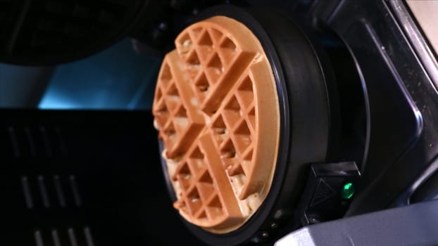 Belgian Viennese Wavy Waffles. The cooking process in an electric waffle iron. Cooking. vertical videos.