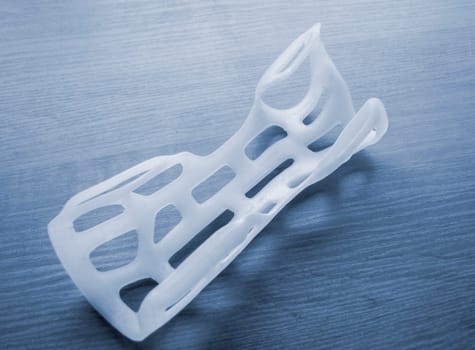 Hand arm splint corset prosthesis langet printed on a 3D printer from molten plastic. Medical orthosis, fixator, plastic overlay created on 3D printer. New modern medical 3D printing technologies