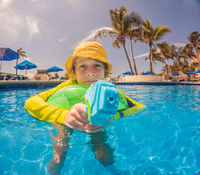 boy fun jumping into the swimming pool, shot through the underwater package.