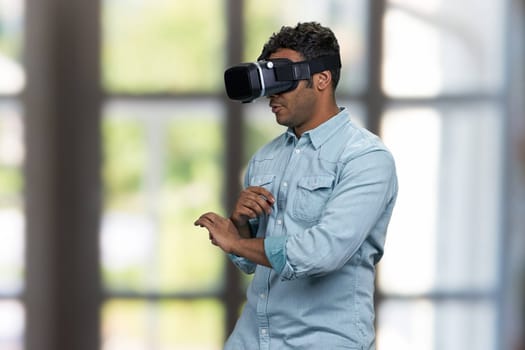 Young african-american guy wearing vr glasses. Future technology concept.