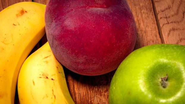 Mix of fresh fruits on wooden table