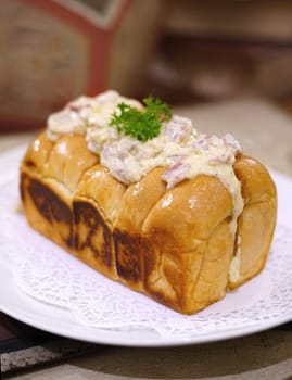 Fresh grilled delicious sandwich with topping and filling plated in white plate, just freshly baked in the restaurant