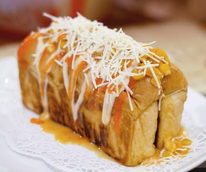 Fresh grilled delicious sandwich with topping and filling plated in white plate, just freshly baked in the restaurant