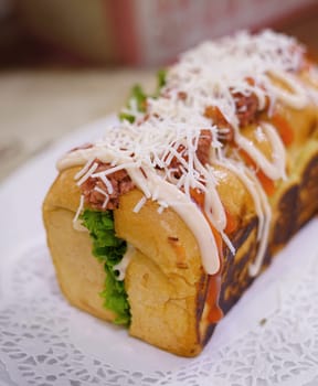Fresh grilled delicious sandwich with topping and filling plated in white plate, just freshly baked in the restaurant