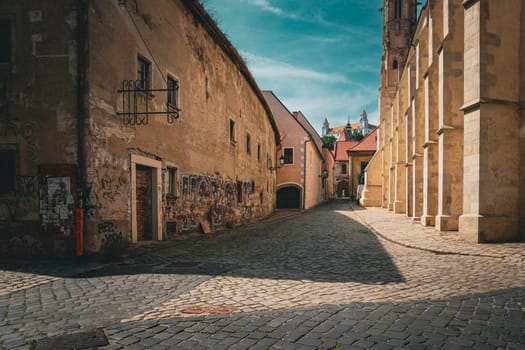 Bratislava, Slovakia, August 25, 2023: Farska Street in Historical Centre of Bratislava with Bratislava Castle in Background