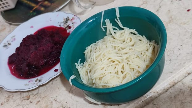 vermicelli in a green plate food, boiled beets. High quality photo