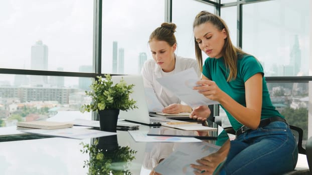 Skilled businesswoman look stress while discuss about financial strategy. Smart business team brainstorming, talking consulting sales plan, idea by using statistic document with tension. Tracery