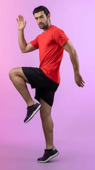 Full body length gaiety shot athletic and sporty young man fitness running cardio exercise posture on isolated background. Healthy active and body care lifestyle.